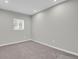 Clean, carpeted bedroom featuring a bright window and neutral walls, perfect for customization at 9950 W 17Th Ave, Lakewood, CO 80215