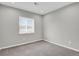 Standard bedroom featuring neutral walls, carpet, window with blinds, and simple electrical outlets at 9950 W 17Th Ave, Lakewood, CO 80215