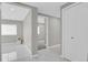 Bright hallway with tile flooring, neutral paint, and inviting transitional spaces at 9950 W 17Th Ave, Lakewood, CO 80215