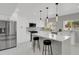 Bright kitchen featuring stainless steel appliances, white cabinetry, and a stylish island with seating at 9950 W 17Th Ave, Lakewood, CO 80215