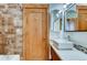 This bathroom features a tile shower and a modern vessel sink with natural wood cabinetry at 1465 S Pearl St # 6, Denver, CO 80210