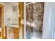 Bathroom featuring a tiled shower, double vanity with stone countertop, and wood trim at 1465 S Pearl St # 6, Denver, CO 80210