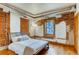 Bedroom with exposed brick, hardwood floors, and natural light from the window at 1465 S Pearl St # 6, Denver, CO 80210