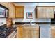 Close-up of the kitchen featuring wooden cabinets, stainless steel appliances, and granite countertops at 1465 S Pearl St # 6, Denver, CO 80210