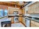 Modern kitchen with stainless steel appliances, wooden cabinets, and a functional island at 1465 S Pearl St # 6, Denver, CO 80210