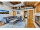 Well-lit living room with exposed ductwork, brick accents, hardwood floors, and comfortable gray sectional at 1465 S Pearl St # 6, Denver, CO 80210