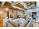 Bright living room featuring exposed brick, wooden ceiling, ductwork, fireplace, and comfortable seating arrangement at 1465 S Pearl St # 6, Denver, CO 80210