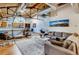Bright living room featuring exposed brick, ductwork, wooden ceilings and a comfortable seating arrangement at 1465 S Pearl St # 6, Denver, CO 80210