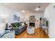 Living room features hardwood floors, fireplace, and natural light at 1834 S Oakland St, Aurora, CO 80012