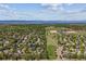 An aerial view showcases the neighborhood, school, and the beautiful mountain views in the distance at 5373 E Links Cir, Centennial, CO 80122
