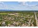 This aerial view captures the beautiful neighborhood, the school and open space, and the mountains in the distance at 5373 E Links Cir, Centennial, CO 80122