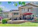 Inviting backyard with a large patio, outdoor seating, and lush greenery, ideal for outdoor living and entertaining at 5373 E Links Cir, Centennial, CO 80122