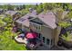 Aerial view of the backyard featuring a patio with dining set, mature trees, and well-manicured lawn at 5373 E Links Cir, Centennial, CO 80122