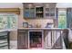 Dry bar has upper cabinets with glass fronts, countertop, and a wine fridge at 5373 E Links Cir, Centennial, CO 80122