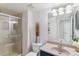 Cozy bathroom with glass-door shower, neutral walls, and granite countertop sink at 5373 E Links Cir, Centennial, CO 80122