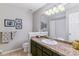 Well-lit bathroom with granite countertops, stylish fixtures, and a shower-tub combination at 5373 E Links Cir, Centennial, CO 80122