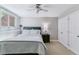 Well-lit bedroom featuring a comfortable bed, bedside table, and window overlooking a lush outdoor view at 5373 E Links Cir, Centennial, CO 80122