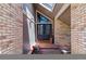 Inviting entryway with brick accents, a stylish front door, and decorative plants welcoming guests at 5373 E Links Cir, Centennial, CO 80122