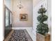 Elegant foyer featuring a chandelier, decorative mirror, and grand staircase, creating a stunning first impression at 5373 E Links Cir, Centennial, CO 80122