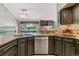 Granite countertops, stainless steel dishwasher, and designer mosaic backsplash are featured in this kitchen at 5373 E Links Cir, Centennial, CO 80122