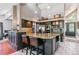 Spacious kitchen with an island, granite countertops, and dark cabinets offers seating and storage at 5373 E Links Cir, Centennial, CO 80122