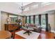 Sunlit living room featuring hardwood floors, elegant decor, and large windows providing serene outdoor views at 5373 E Links Cir, Centennial, CO 80122