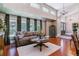 Bright living room with hardwood floors, large windows, and stylish furnishings, offering a comfortable living space at 5373 E Links Cir, Centennial, CO 80122