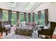 Inviting living room with multiple windows, skylights, plush seating, and stylish decor at 5373 E Links Cir, Centennial, CO 80122
