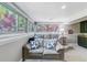 Comfortable living area with large windows, plush couches, and a built-in bar area for entertaining at 5373 E Links Cir, Centennial, CO 80122