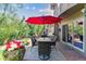Enjoy outdoor living on this patio with an umbrella-shaded dining table, grill, and access to the home at 5373 E Links Cir, Centennial, CO 80122