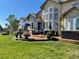 Expansive backyard with lush lawn, patio with outdoor seating, and luxurious hot tub for relaxation at 6561 Ocaso Dr, Castle Pines, CO 80108