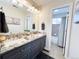 Bathroom featuring double vanity with stone countertop, tile floor, and separate toilet and shower at 6561 Ocaso Dr, Castle Pines, CO 80108