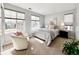 Well-lit bedroom features large windows, stylish decor, and comfortable seating and plenty of natural light at 6561 Ocaso Dr, Castle Pines, CO 80108