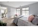 Light and bright bedroom with large windows, slider closet, neutral wall color and stylish decor at 6561 Ocaso Dr, Castle Pines, CO 80108