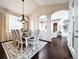 Elegant dining room featuring a decorative chandelier and a neutral-toned area rug at 6561 Ocaso Dr, Castle Pines, CO 80108