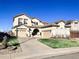 Charming home featuring a well-manicured lawn, driveway and a three-car garage at 6561 Ocaso Dr, Castle Pines, CO 80108