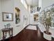 Spacious two-story foyer with elegant hardwood floors, recessed lighting, and decorative niches at 6561 Ocaso Dr, Castle Pines, CO 80108
