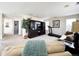 Upstairs living room with carpeting, a large TV, a treadmill, a leather sofa, and multiple windows at 6561 Ocaso Dr, Castle Pines, CO 80108