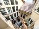Aerial view of an outdoor patio featuring a stone fireplace, comfortable seating, and decorative string lights at 6561 Ocaso Dr, Castle Pines, CO 80108