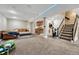 Spacious finished basement with bar area, comfortable seating, and carpeted flooring at 19346 E Prentice Ln, Centennial, CO 80015
