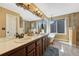 Bright bathroom with a double vanity, soaking tub, and glass-enclosed shower at 19346 E Prentice Ln, Centennial, CO 80015