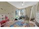 Playful ' bedroom with a large window, colorful decor, and a spacious carpeted area at 19346 E Prentice Ln, Centennial, CO 80015