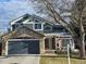 Charming two-story home with a stone-accented garage and inviting front porch at 19346 E Prentice Ln, Centennial, CO 80015