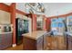 Spacious kitchen showcasing a center island, black appliances, and wooden flooring at 19346 E Prentice Ln, Centennial, CO 80015
