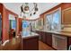 Well-lit kitchen featuring granite countertops, stainless steel appliances, and dark wood cabinets at 19346 E Prentice Ln, Centennial, CO 80015
