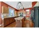 Charming kitchen equipped with an island, modern appliances, and wood cabinetry at 19346 E Prentice Ln, Centennial, CO 80015