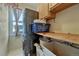 Efficient laundry room with stacked washer/dryer and storage, located near a window at 19346 E Prentice Ln, Centennial, CO 80015