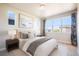 Cozy bedroom features a large window, curtains, accent pillows, and lamps on each side of the bed at 6940 Clay St, Denver, CO 80221