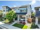 Charming two-story home featuring a cozy front porch with a hanging swing and beautifully landscaped yard at 6940 Clay St, Denver, CO 80221