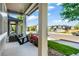 View from the porch of a neighborhood street with a swing, flowers and manicured lawn at 6940 Clay St, Denver, CO 80221